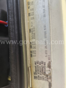 Label showing vehicle specifications and weights on a door jamb of a Freightliner cab. Includes VIN, axle and tire data, weights, and production codes.
