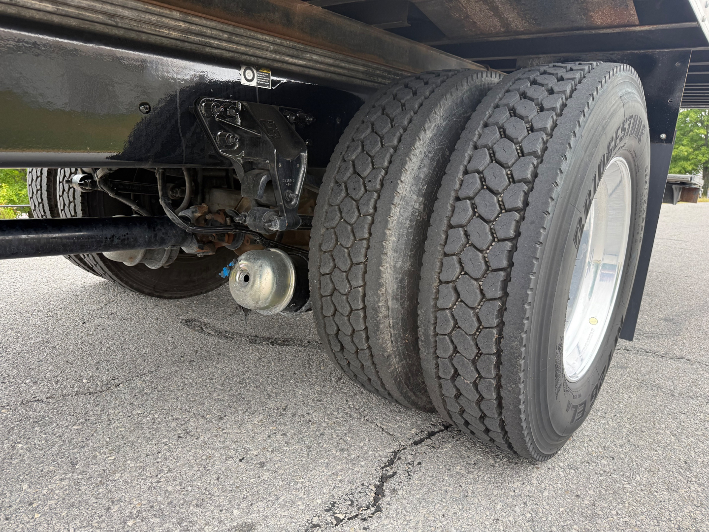 Kenworth T380 undercarriage with rear dual tires and suspension components visible; chassis, air lines, and braking system in view.