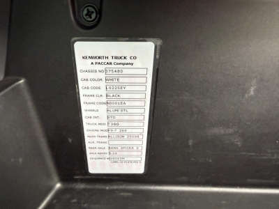 Kenworth truck chassis tag showing model and spec details: CAB COLOR WHITE, CHASSIS NO 75480, TRUCK MOD T380, ENGINE MT 9.3L? (text partial) MAIN TRANS ALLISON 2500R, WHEELS ALUM/STL