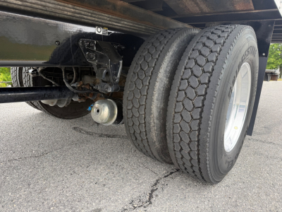 Kenworth T380 chassis showing tandem rear wheels and suspension components; dual rear tires and undercarriage visible.