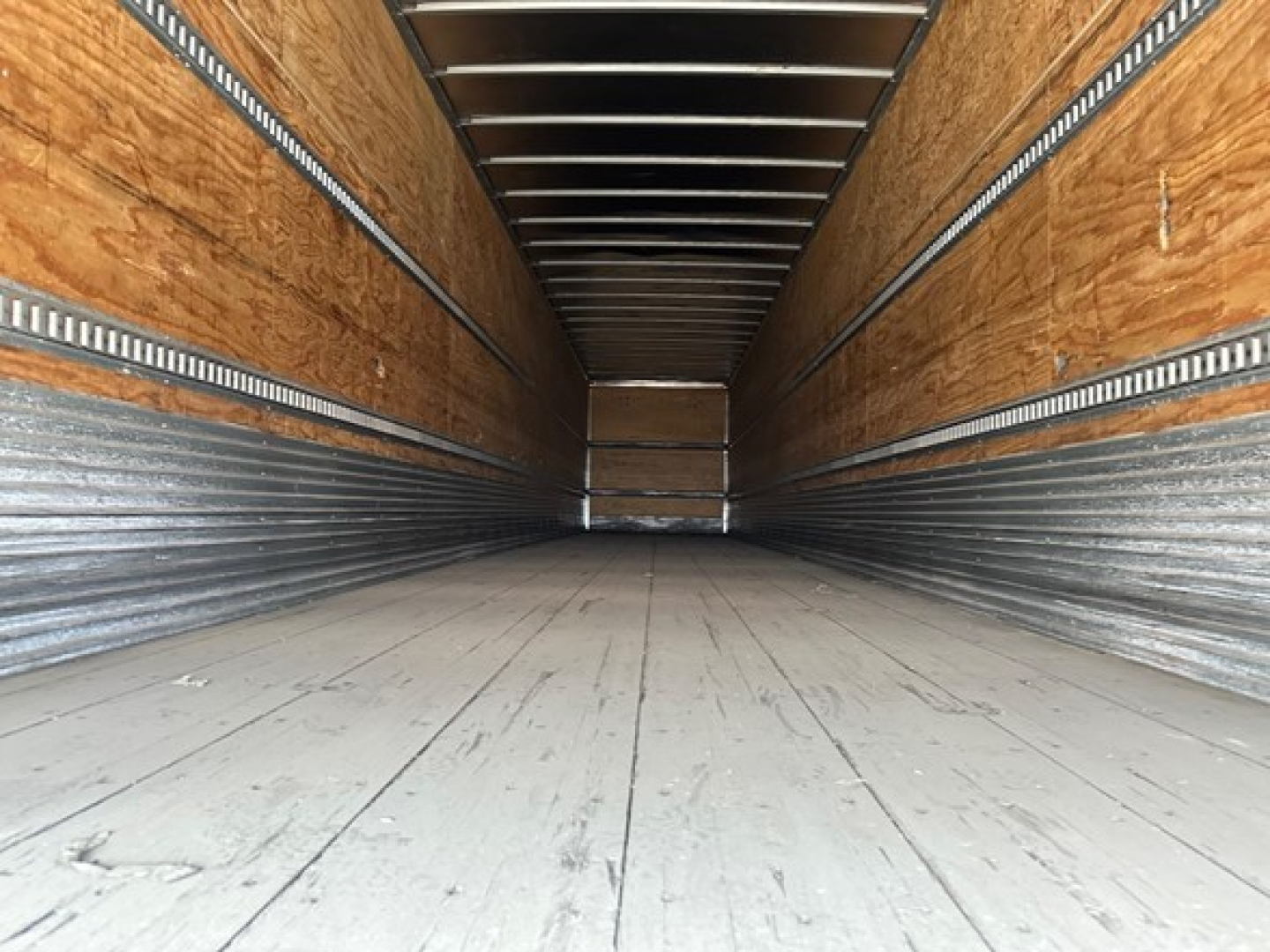 Hyundai 2015 air ride dry van trailer interior showing wooden side walls and metal runners with empty cargo space.