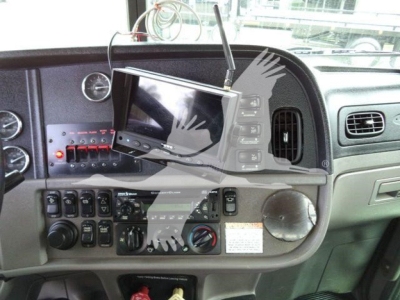 Interior of a Peterbilt 367 dash showing a mounted aftermarket monitor and control panel with gauges and switches.