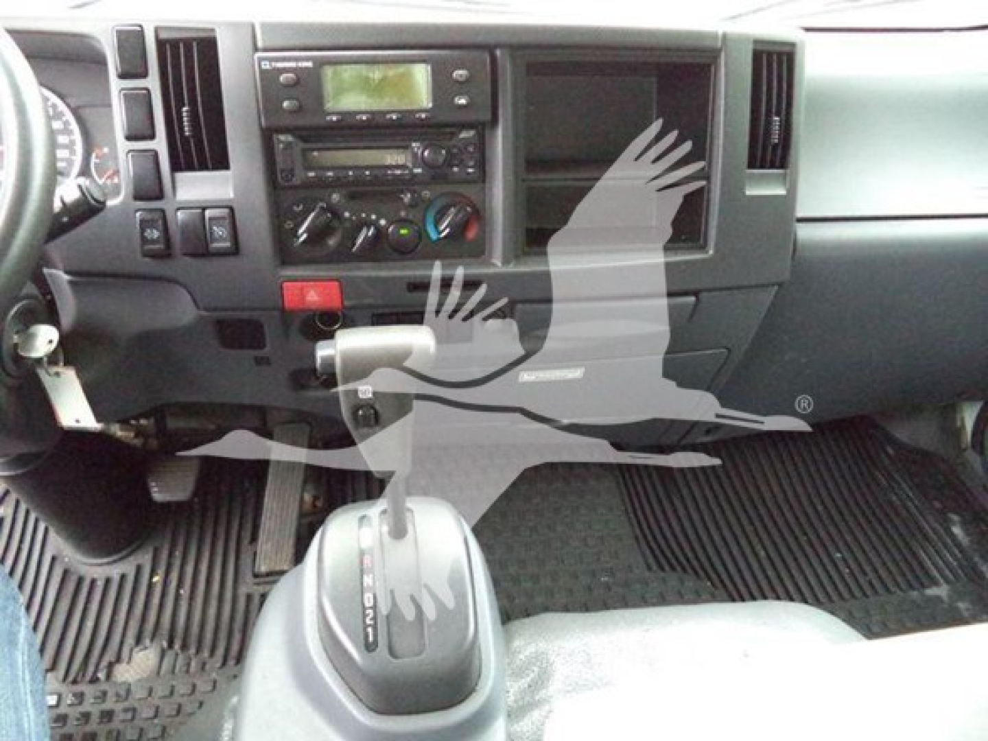 Isuzu NQR interior dashboard and gear selector area with steering wheel visible