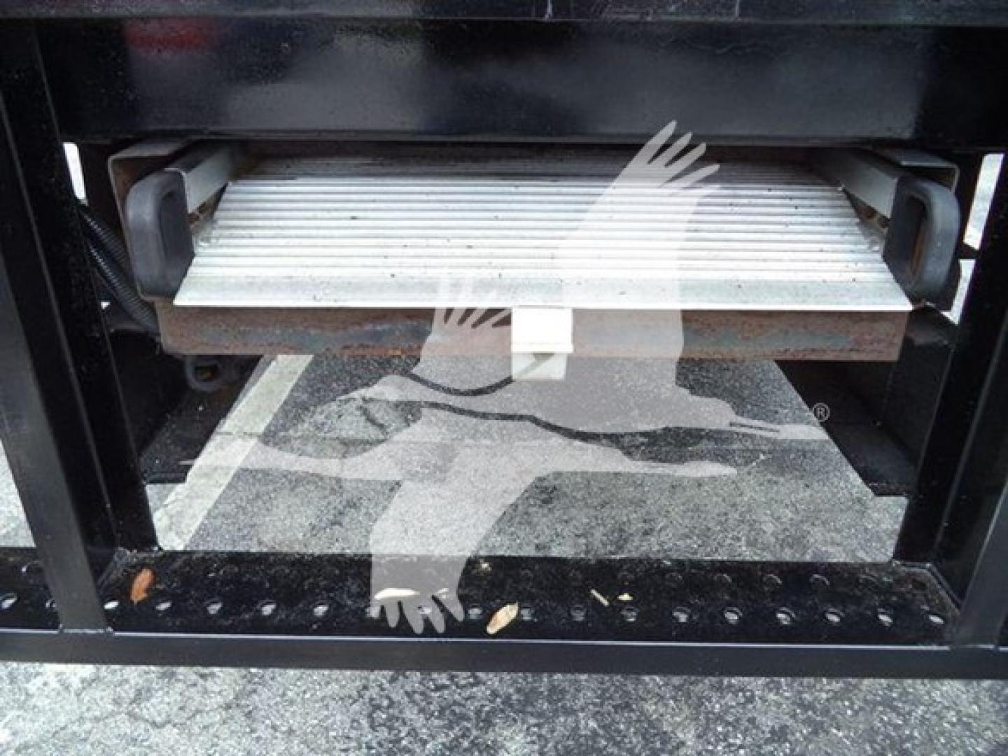 Isuzu NQR refrigeration truck loading area with slide-out drawer and metal platform visible.