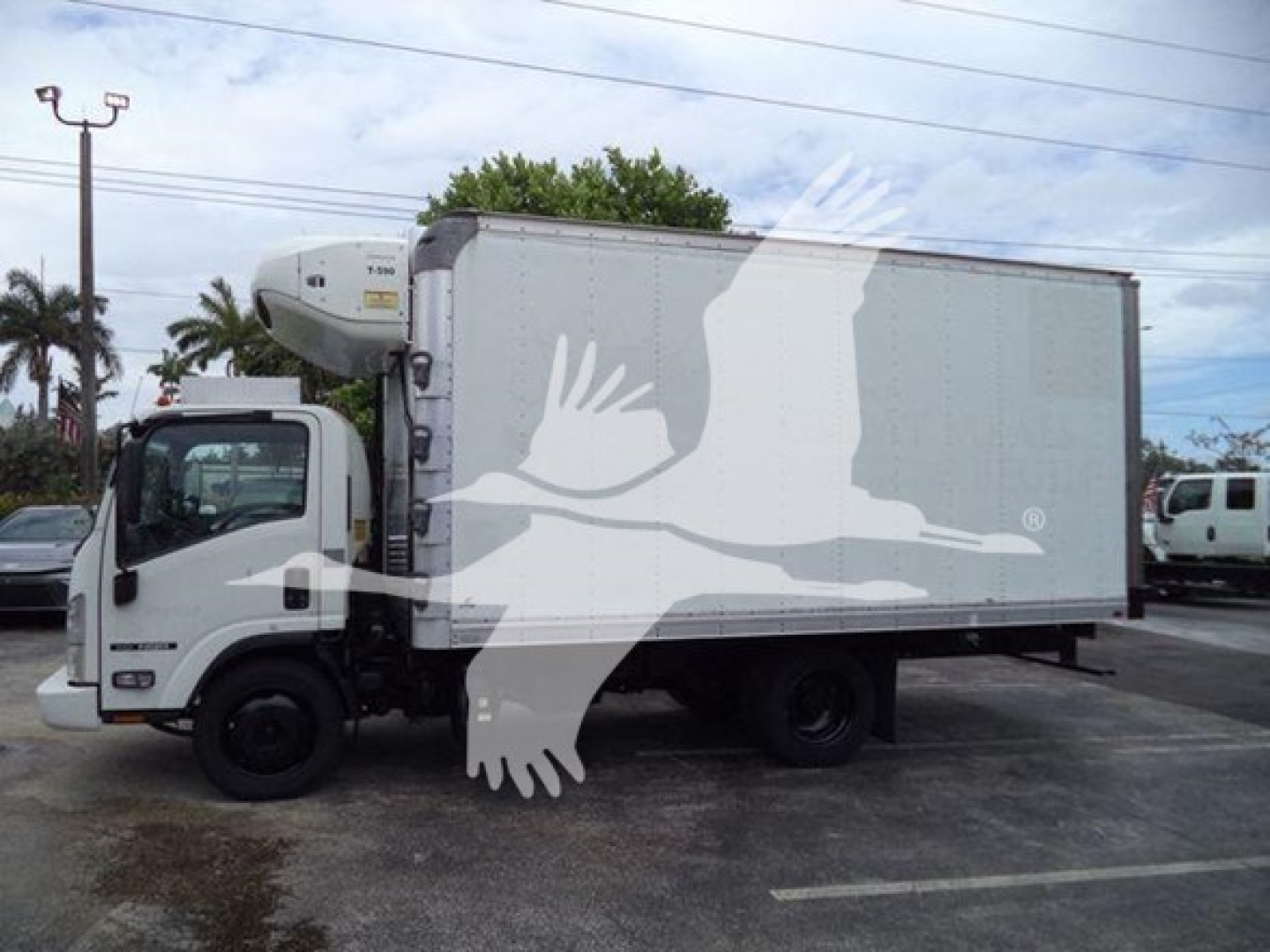 Isuzu NPR-style refrigerated truck with white cab and cargo box, stock number T00470, side view showing refrigeration unit at cab-front.