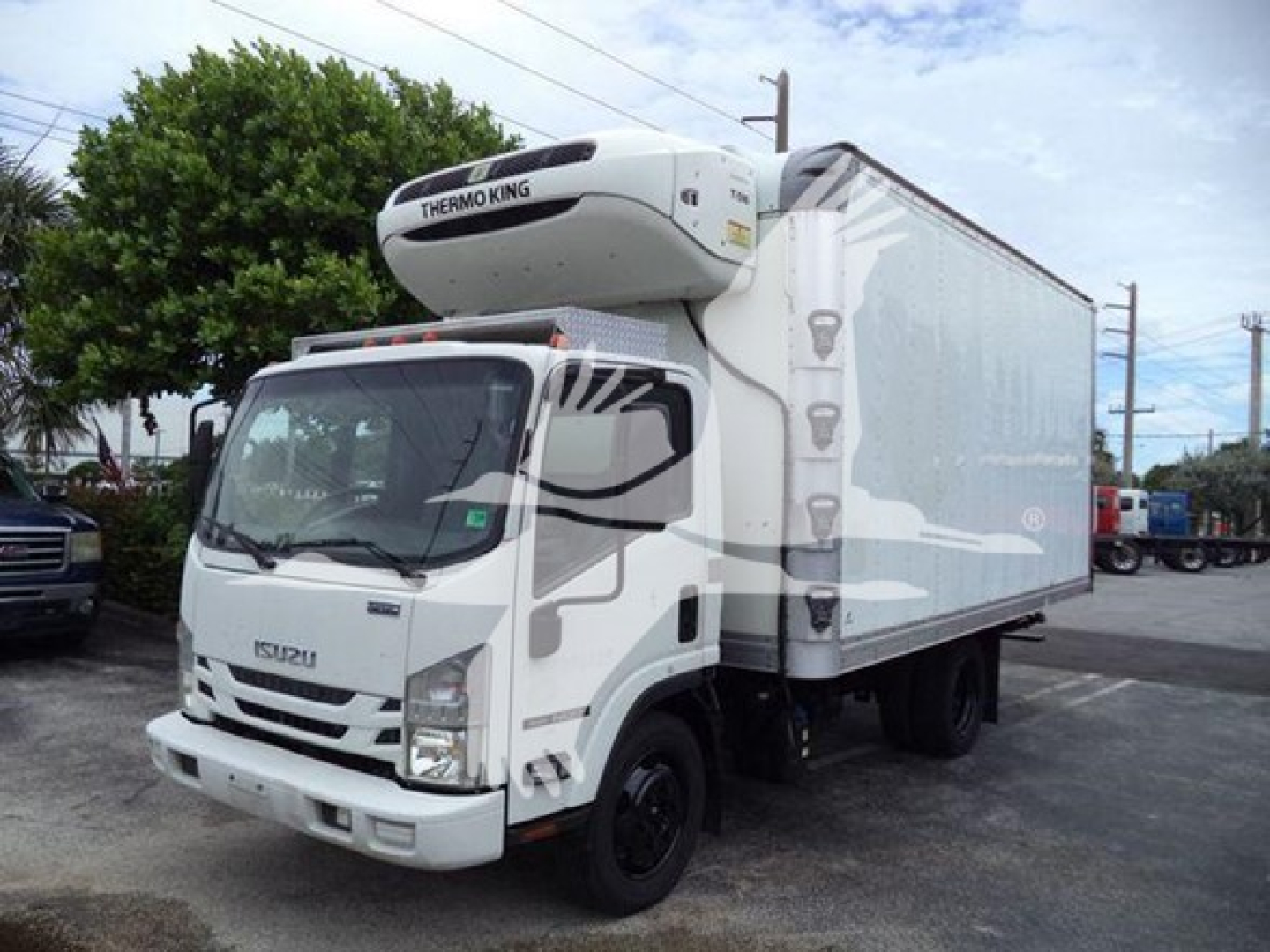 Isuzu refrigerated truck with Thermo King unit on top showing white cab and cargo box