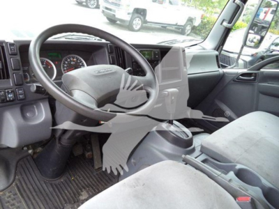 Isuzu NQR truck cockpit showing steering wheel and dashboard with center console and driver seat in view.