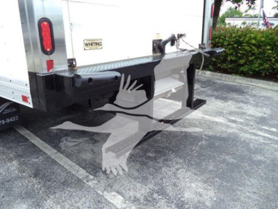 Isuzu NQR refrigerated truck rear view showing bumper, hitch, and taillight area; sticker with WHITING brand; metal bumper and platform.