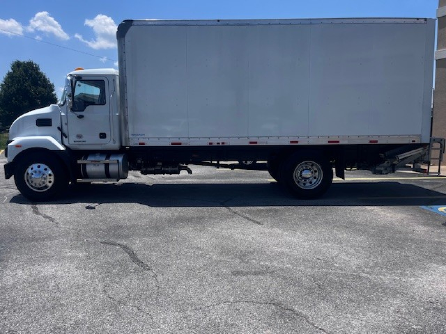 Mack MD6 box truck side view showing cab and large cargo box.