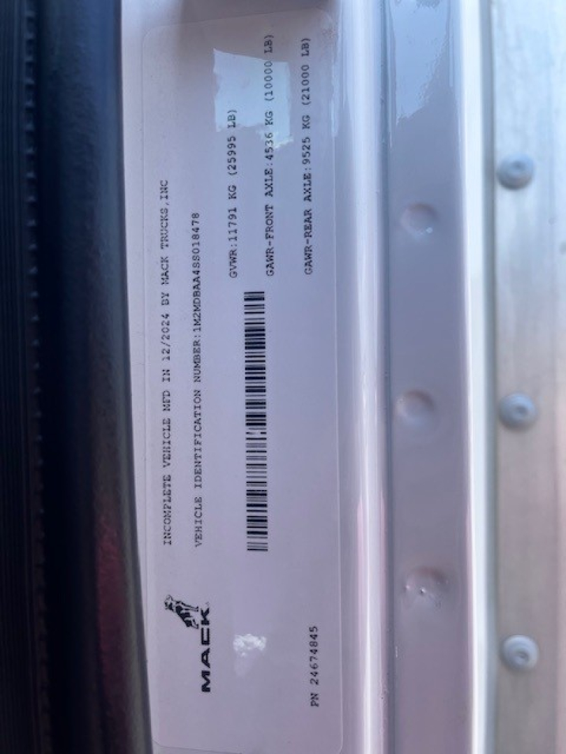 Vehicle VIN sticker, Mack MD6 side view showing vehicle identification and barcodes with serial details.