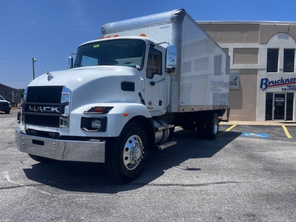 White 2025 Mack MD6 medium-duty box truck with long cargo box, chrome front bumper, parked in lot.