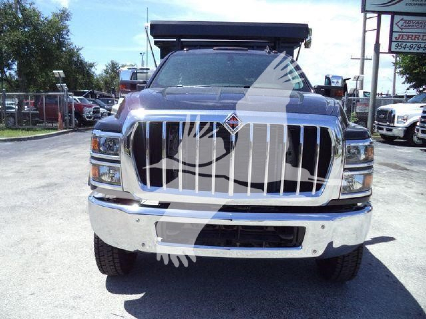 Front view of a 2023 International CV roll-off truck with large chrome grille, dual headlights, and a raised cab, stock CV515REG14SNG1.