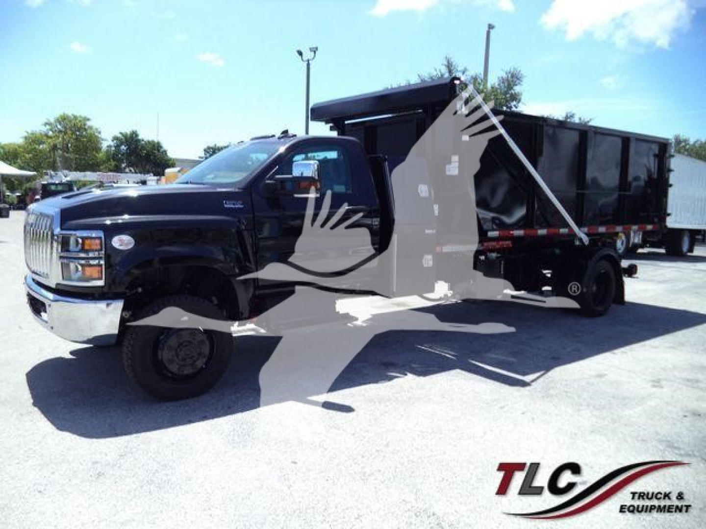 2023 International CV truck with roll-off dumpster in black, side view showing cab and trailer.