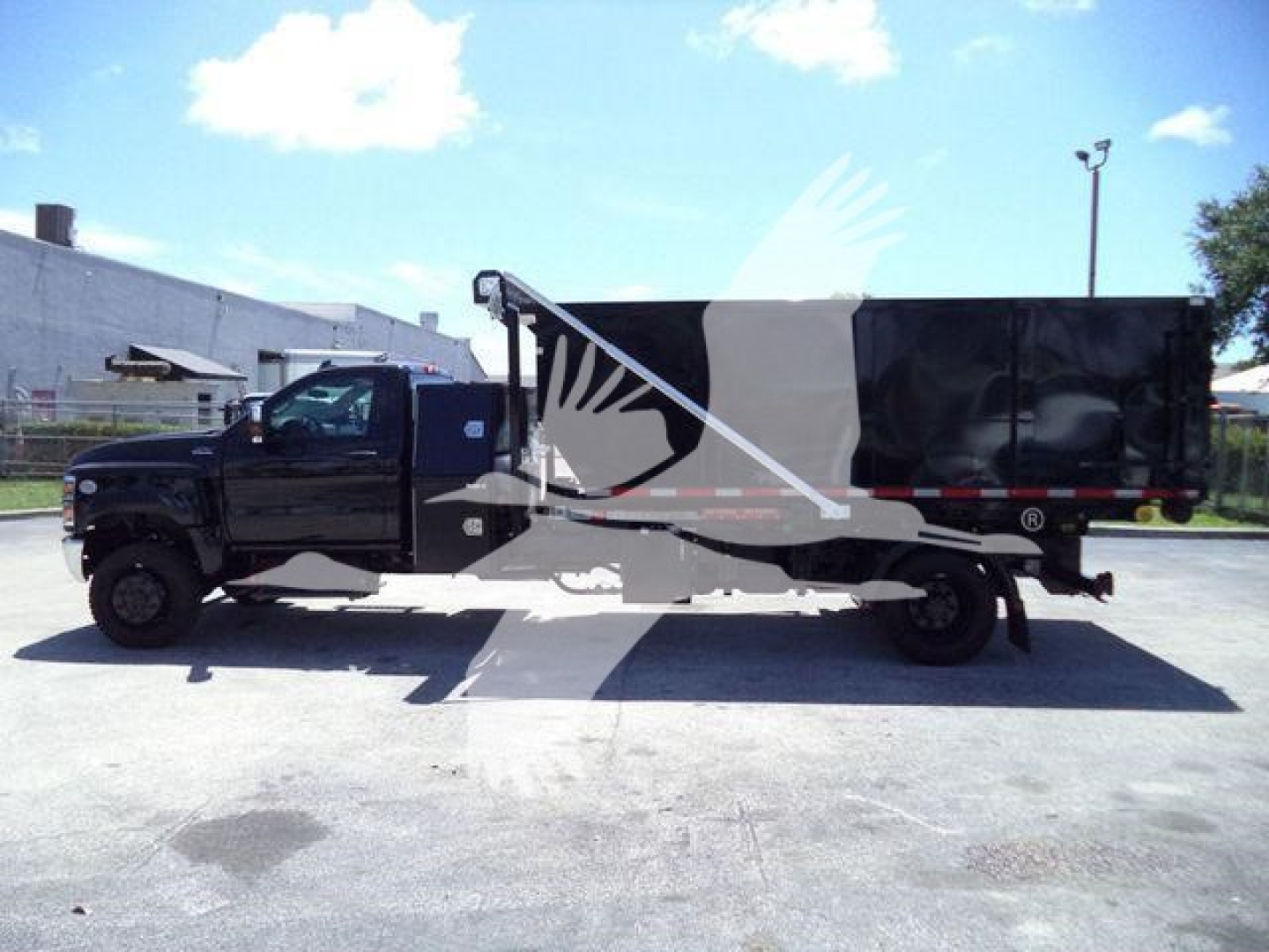 Truck with a black cab and roll-off bed, side view. Visible text includes stock number CV515REG14SNG1 and category/type information in listing context.