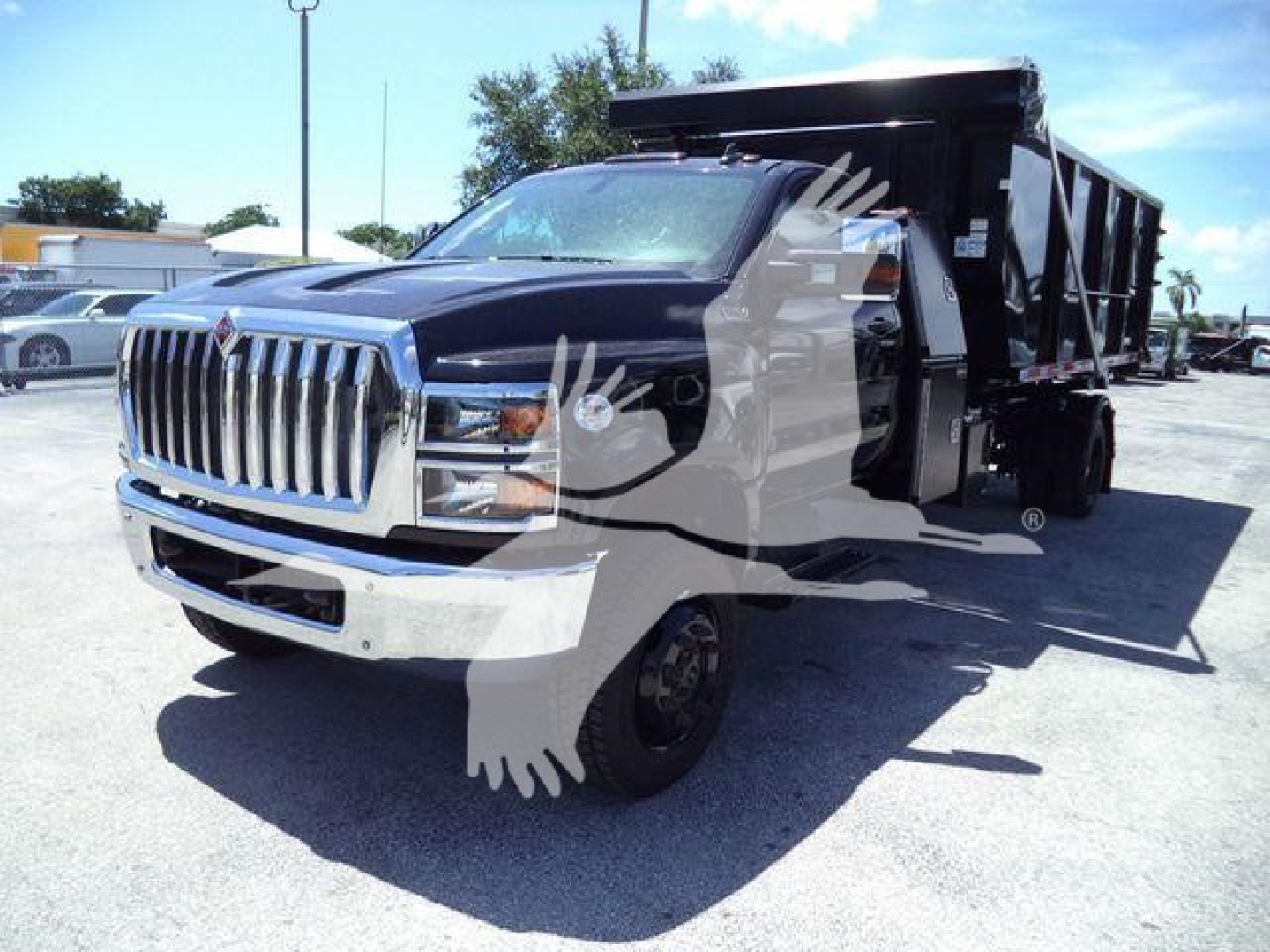 Truck in service yard showing front grille and dump body on International CV rolling chassis