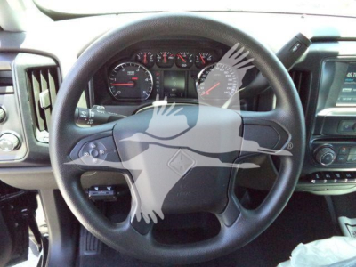 Interior of a 2023 International CV truck showing steering wheel and dashboard gauges; gear shifter and center console visible.