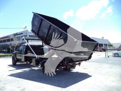 Dump truck with raised bed in a parking lot. Visible text: Stock Number CV515REG14SNG1. Category: Rolloff. Type: Trucks. New Used: New.