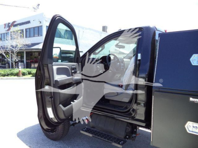 Truck interior view with front door and step, cab of a 2023 International CV rolloff truck, open door showing steering wheel and dashboard area.