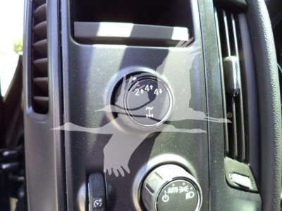 Dashboard control knob with four-wheel drive selector showing 2H 4H 4L on a truck cabin interior, with an air vent above.