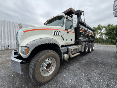 Truck cab and dump body of a 2019 Mack Granite in a gravel lot.