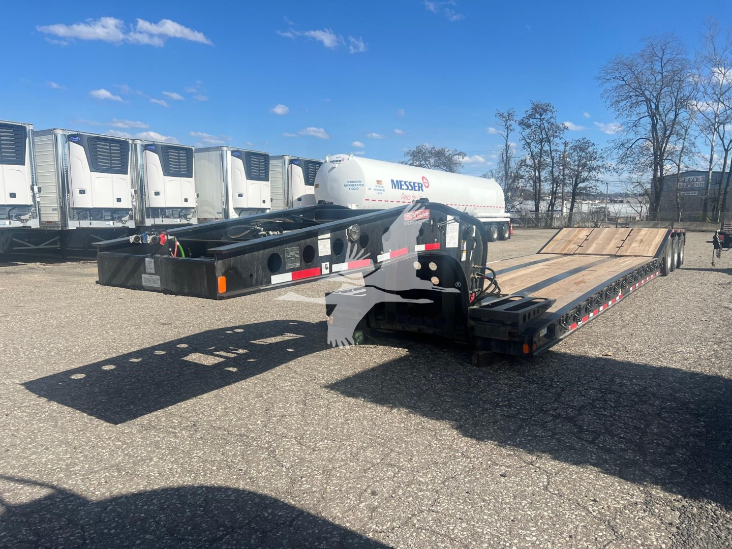  Fontaine 55 PVR Pro lowboy trailer with flatbed deck and HPI gas tank visible, in-service showing hydraulic components and rear ramps.