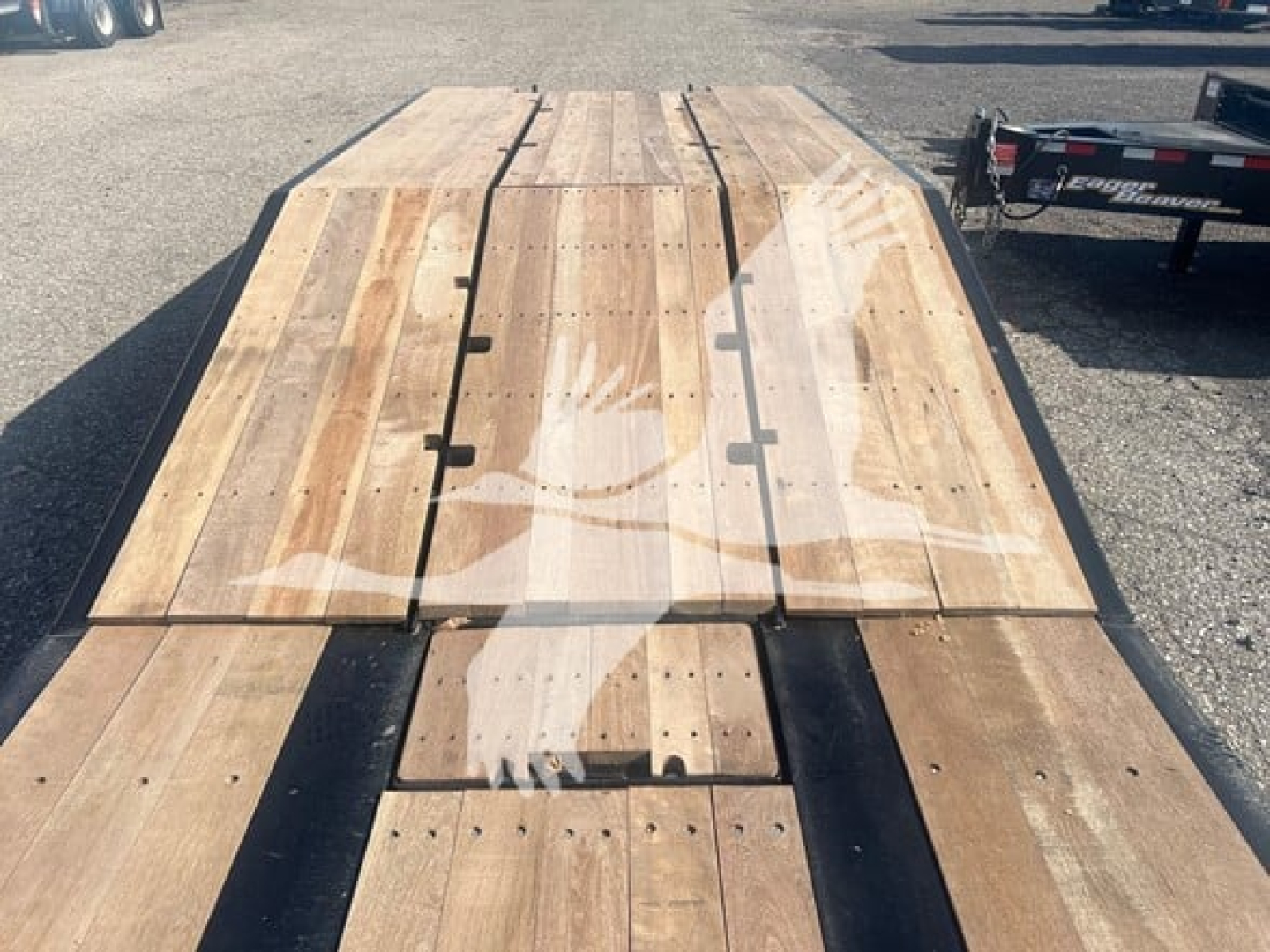 Fontaine 55 PVR Pro lowboy trailer deck showing wooden planks and securing latches.