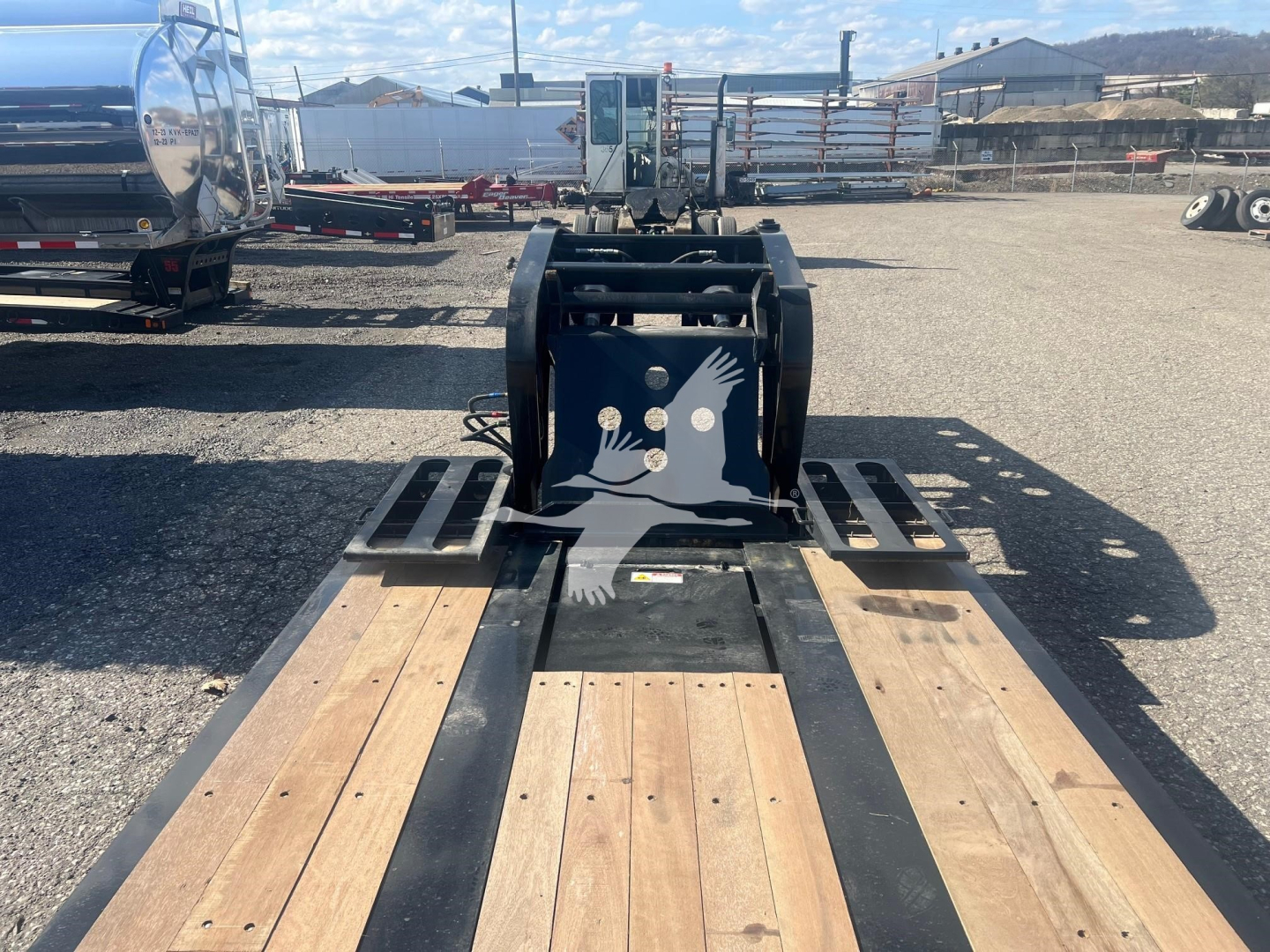 Fontaine lowboy trailer deck showing wooden planks and gooseneck hitch with hydraulic system and frame; V35A6662 visible on stock tag.