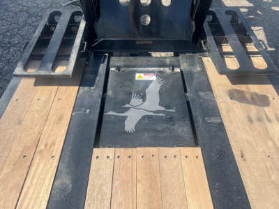 Pro view of Fontaine 55 PVR Pro lowboy trailer deck with wooden boards and metal side rails.