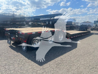  Fontaine 55 PVR Pro lowboy trailer in a parking lot showing dual rear sections and wooden deck with multiple axles.