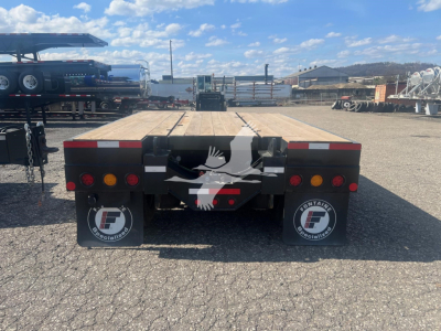 Flatbed trailer rear view with Fontaine logo on mud flaps and tail lights, wooden deck, 55 ft PVR Pro lowboy trailer.