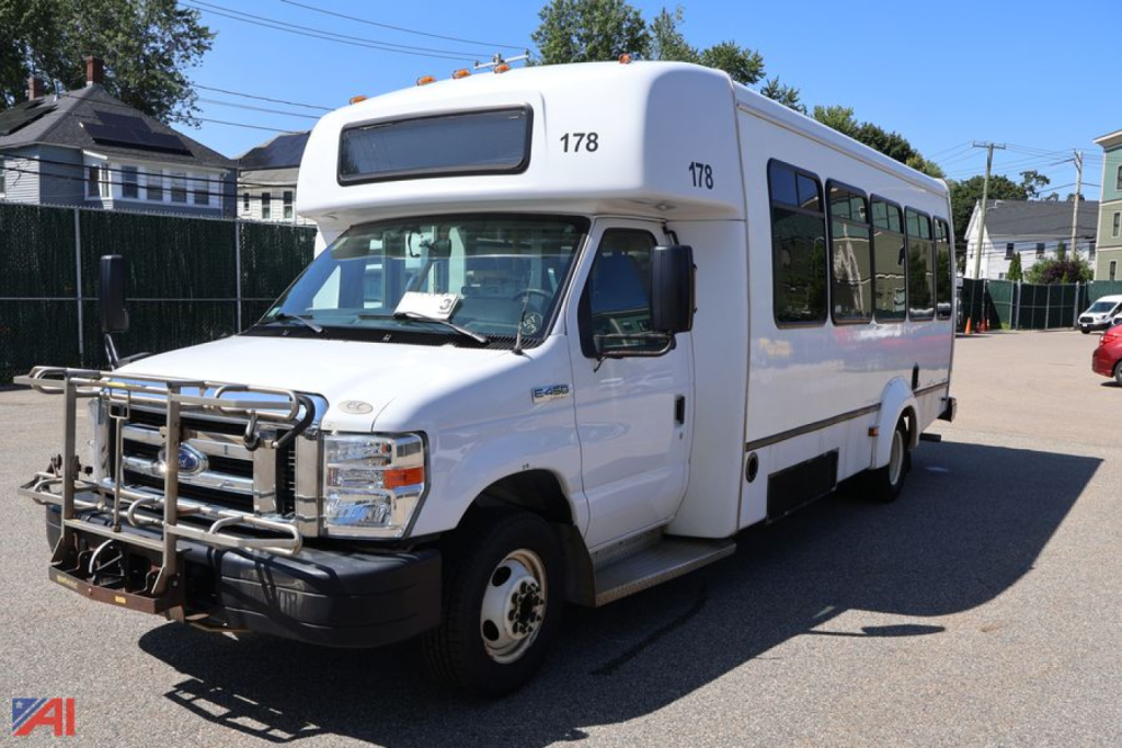Ford E450 shuttle bus with wheelchair ramp area, front bull bar, and number 178 on hood and side, white body, passenger windows along length.