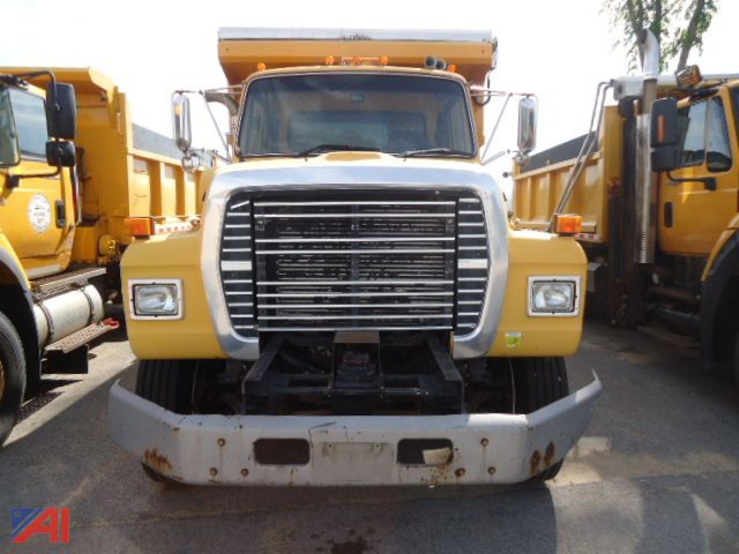 Front view of a 1995 Ford L8000 dump truck showing large grille, headlights, and front bumper.
