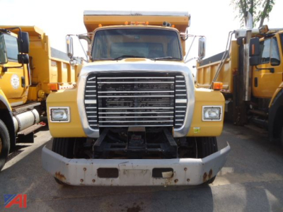 Front view of a 1995 Ford L8000 dump truck showing large grille, headlights, and front bumper.