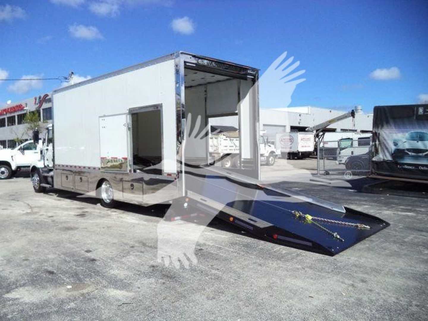 MD6 rollback truck body with open rear ramp and boxes showing in-service equipment trailer.