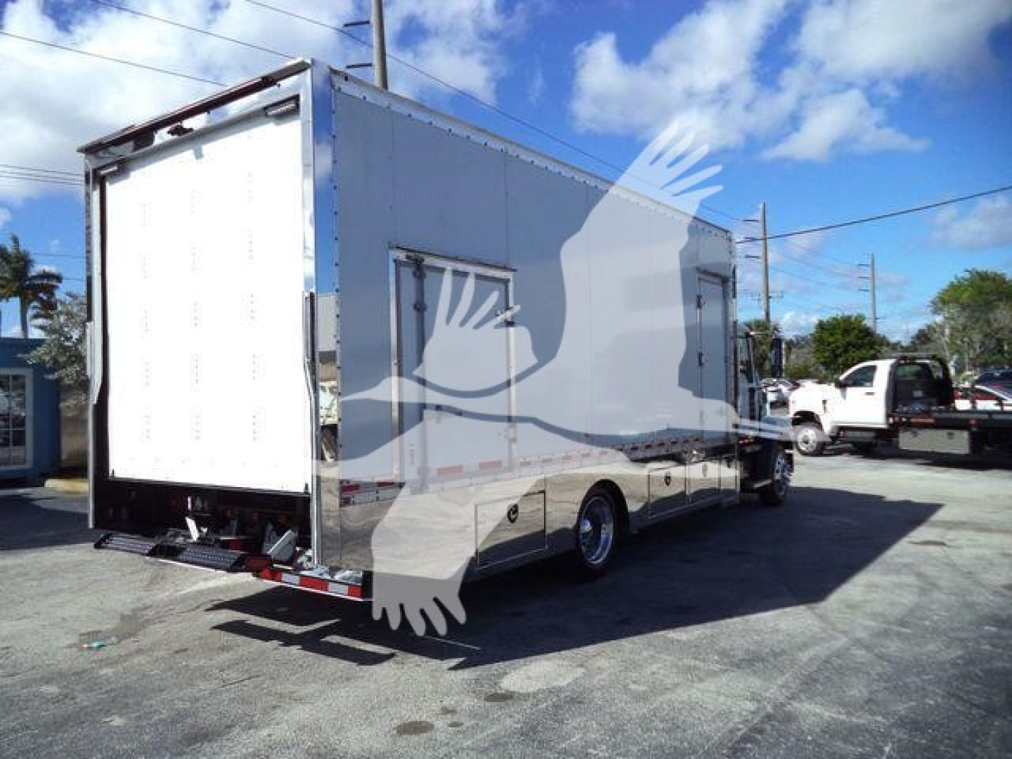 2026 Mack MD6 rollback truck side and rear view showing cargo box and dual rear wheels.