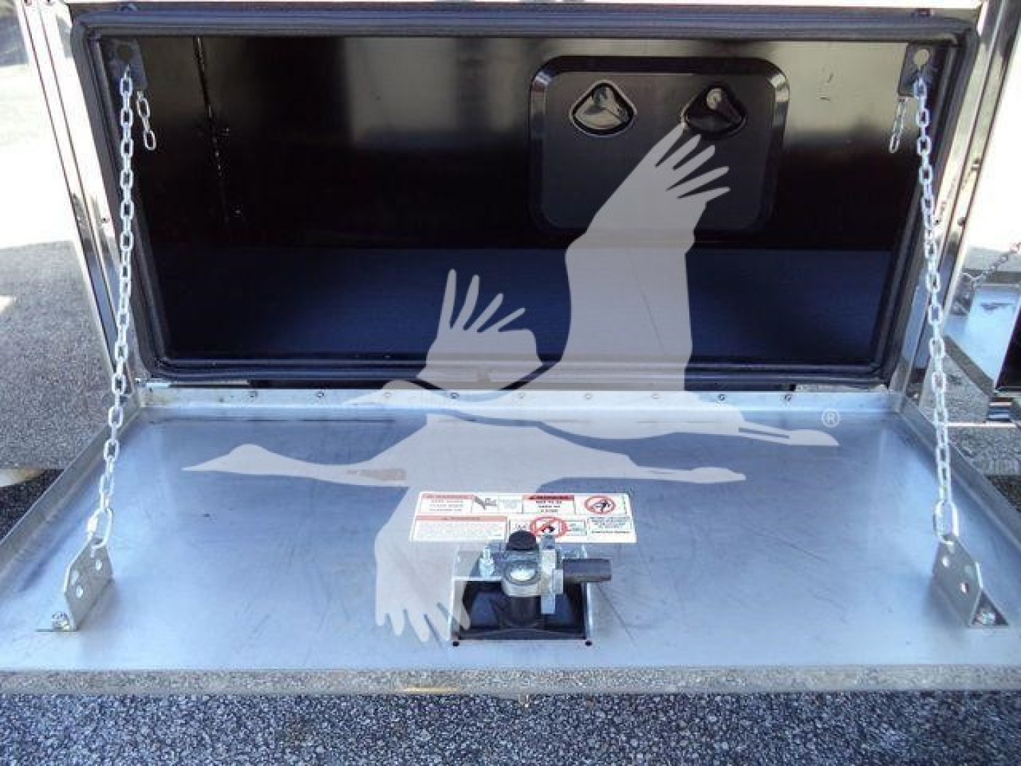 Truck storage bed in open tailgate showcasing interior of MACK MD6 rollback truck with safety chains and mounting hardware.