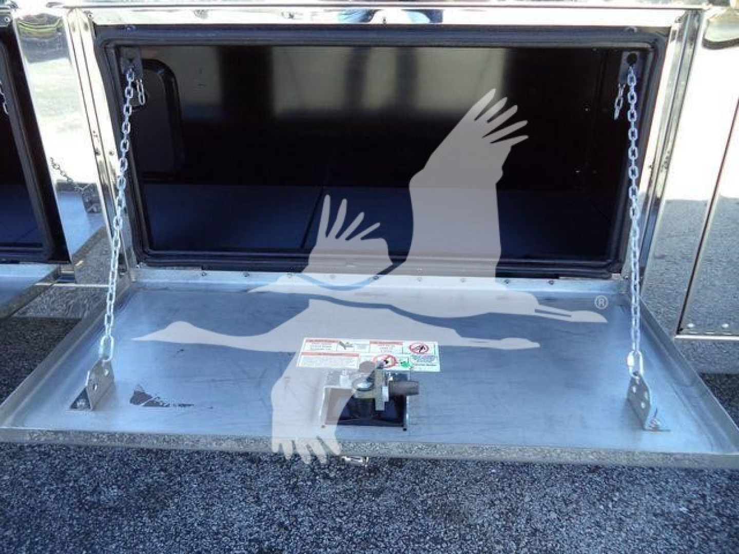 MD6 tow box area of a 2026 Mack MD6 rollback truck showing open storage compartment with chains on either side.