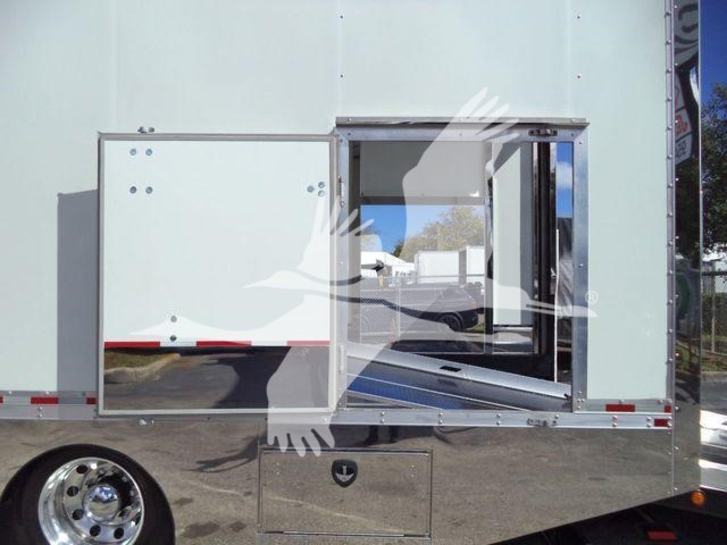 MD6 rollback truck side showing loading access door with empty interior and exterior silver door, light green body, chrome wheel visible.
