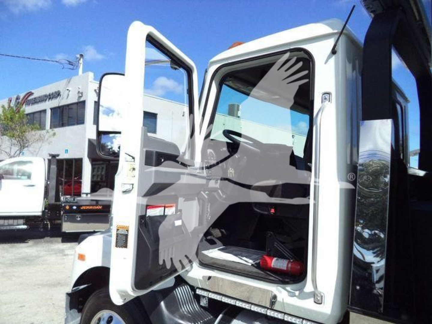 MD6 truck cab with open doors showing interior and steps, MD6 model badge may be on door, roll-back tow truck look.