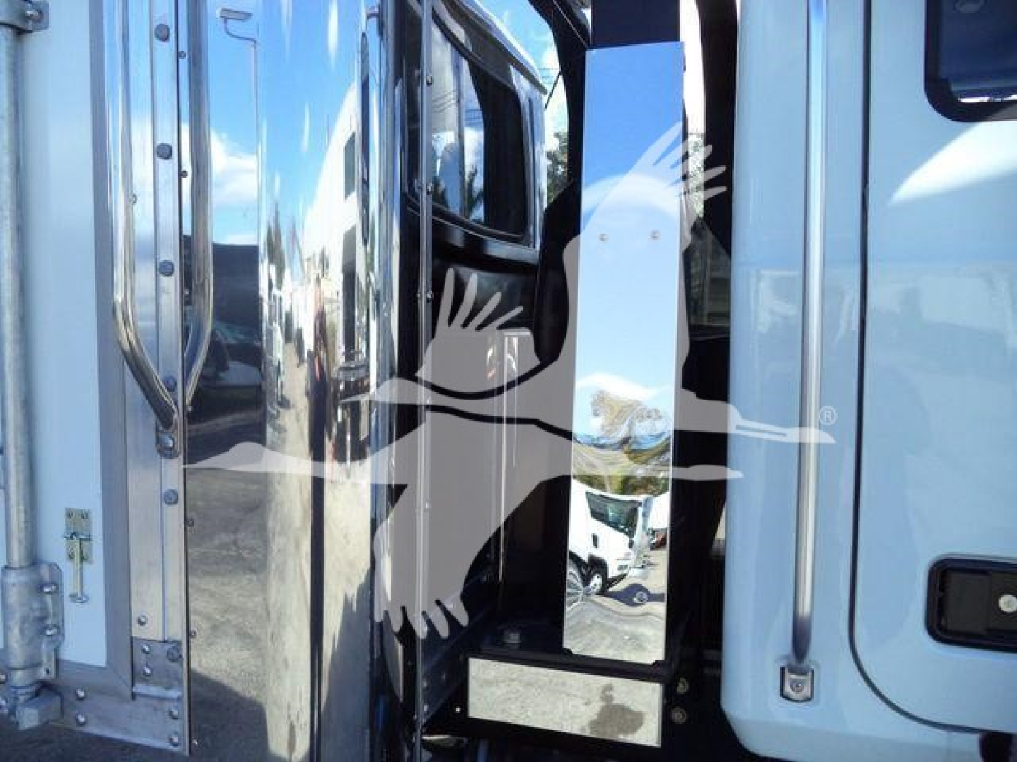 MD6 truck cab edge with steps and door frame, side mirror housing, chrome and black components visible.