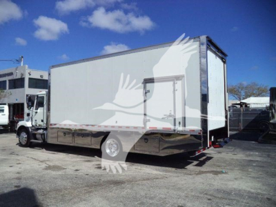 Truck body showing a 2026 Mack MD6 rollback truck with a white box and rear lift, stock number MD6TOWBOX2.