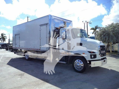 Truck has a large box body on a Mack MD6 chassis, with a white cab and large cargo box. Visible text on truck? none legible. Stock number MD6TOWBOX2 may be in listing but not readable on image.