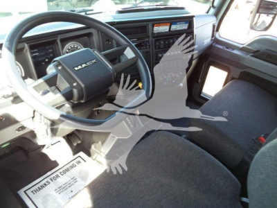 Mack MD6 truck interior showing steering wheel and driver seat with dashboard and controls visible.