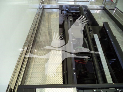 Mack MD6 component view showing recovery truck bed mechanism and platform with metal diamond plate floor and rails.