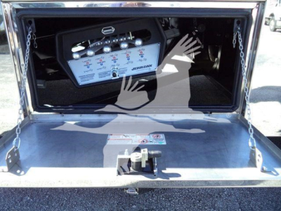 Mack MD6 rollback truck bed showing control panel with gauges and switches mounted in the rear toolbox area.