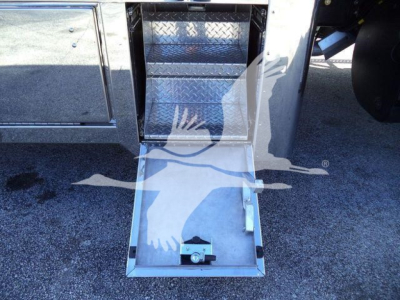 MD6 Mack rollback truck entry with diamond-plate steps and open hatch, showing metal platform and foot pedal.