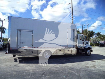 Truck side view showing a large box truck with a rollback utility body, MD6 model, with stock MD6TOWBOX2.
