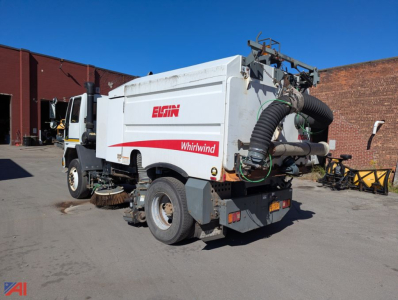 Elgin Whirlwind street sweeper unit mounted on Sterling SC8000 chassis with rear hose and debris intake, visible side panels and branding.
