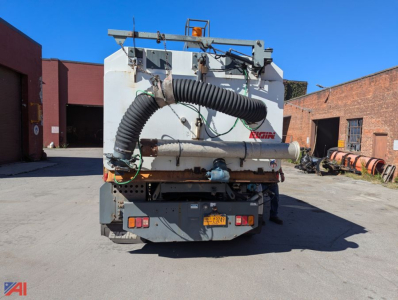 Rear view of a used 2007 Sterling SC8000 cargo sweeper truck showing a large flexible intake hose, exhaust, and back-of-cath hopper with 'ALGIN' branding.