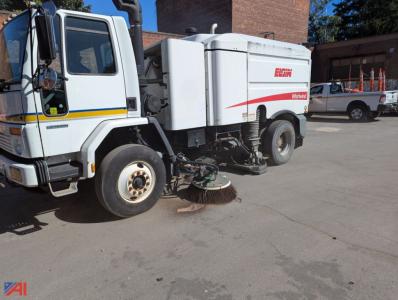 Front-left view of a 2007 Sterling SC8000 cargo sweeper truck with an Elgin brand street sweeper unit attached; visible labels include Elgin on the side and swept area with brushes under the vehicle.